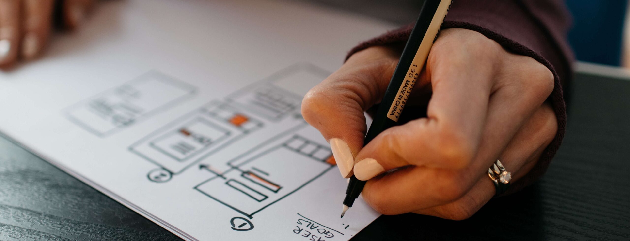 designer drawing wireframes with pen